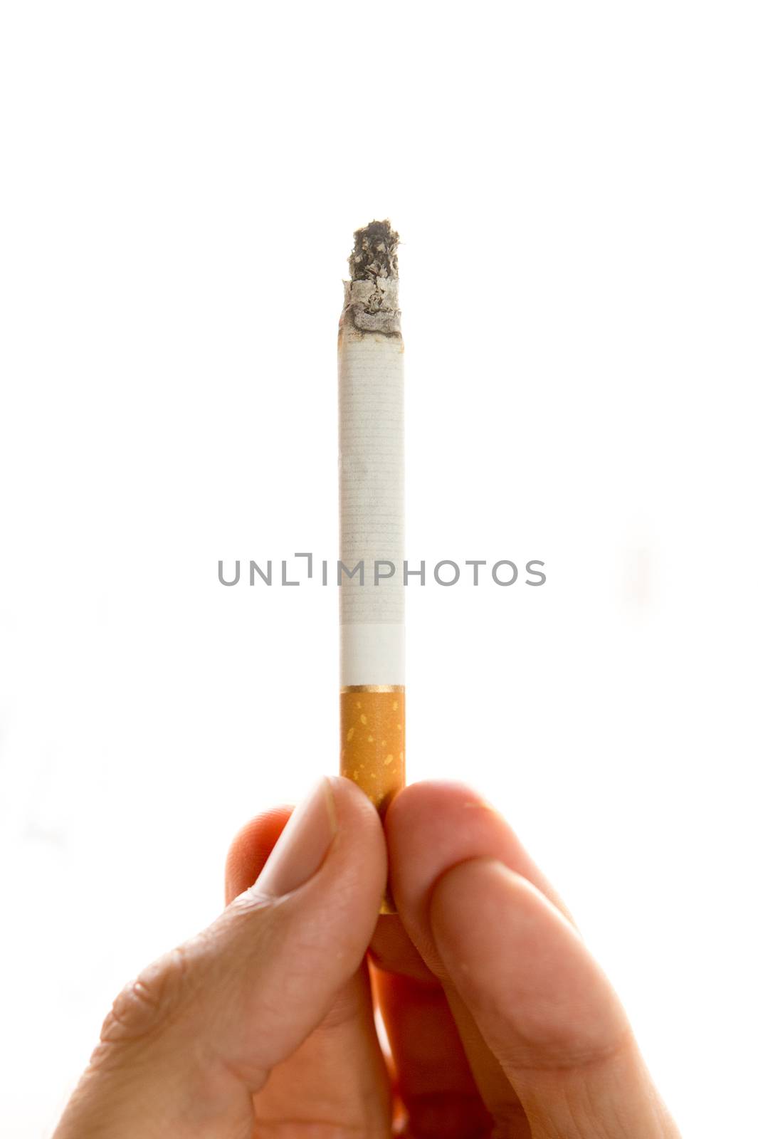Male hand holding a cigarette on white background