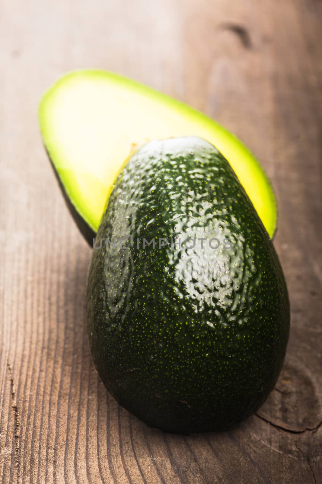 Avocado on the wooden table colse up