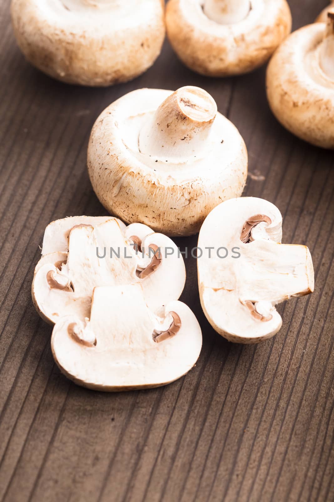 Champignons and slices on the wooden table closeup