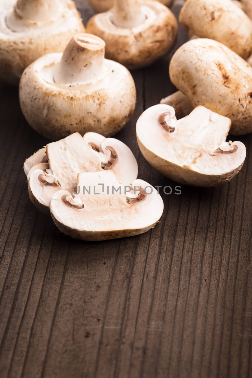 Champignons and slices on the wooden table closeup