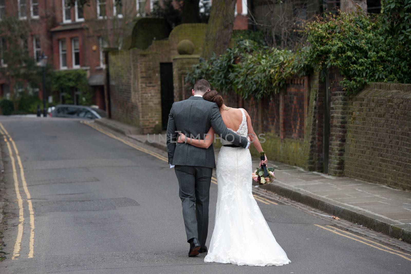 Bride and Groom walking away from the camera after their wedding 