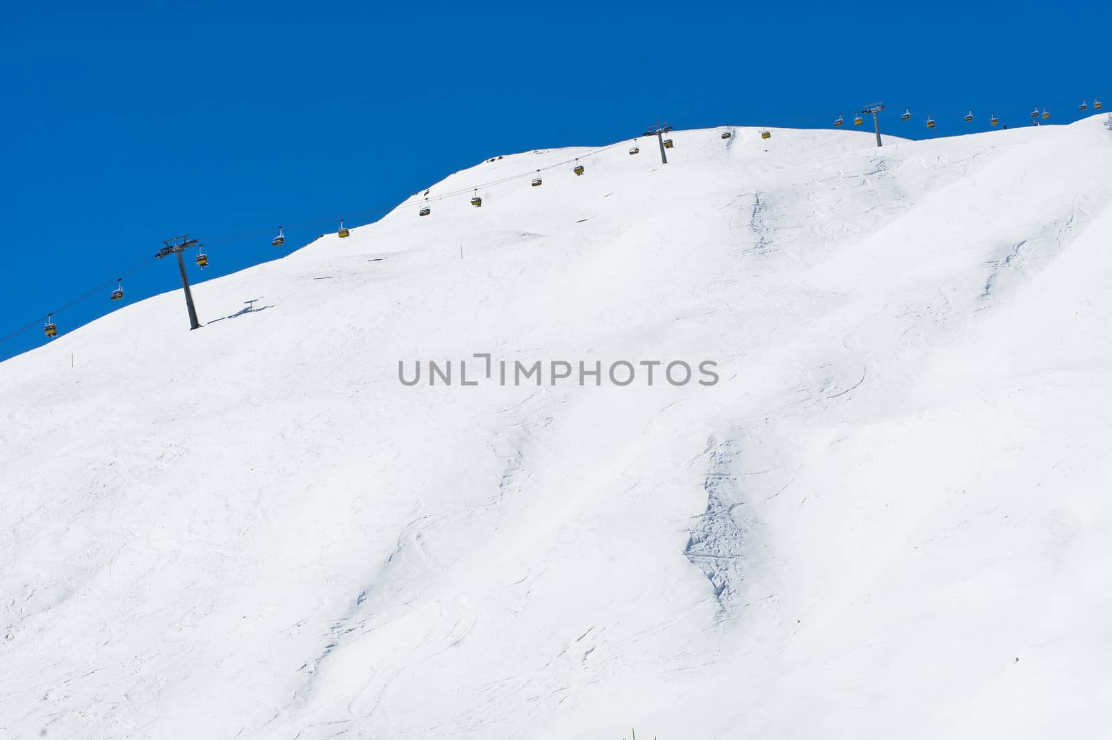 Chairlift along Ski Slope at a clear winters day in Saint Moritz, Switzerland