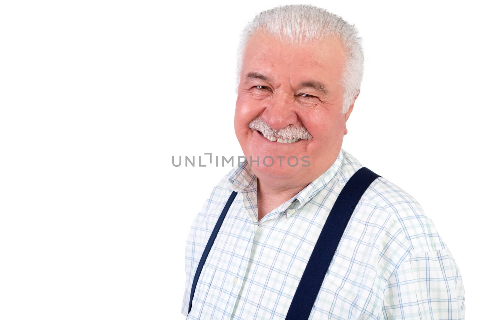 Smiling jovial senior grey-haired man wearing braces looking at the camera with a beaming smile, isolated on white with copyspace