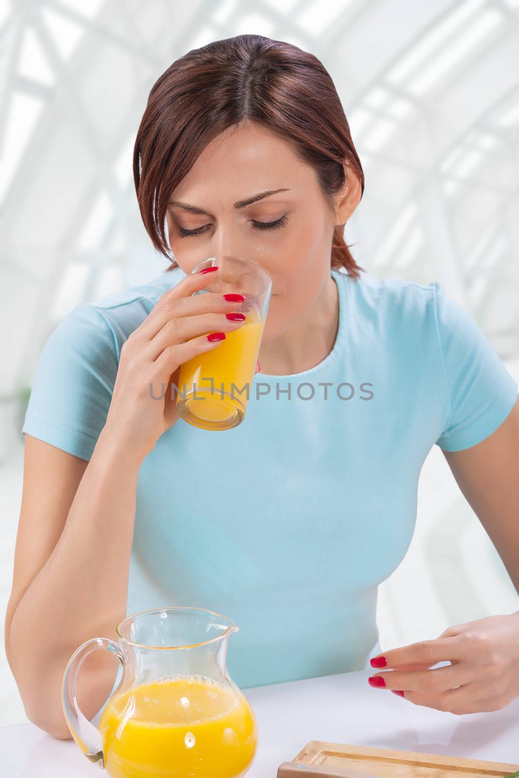 beatiful female drinking orange juice