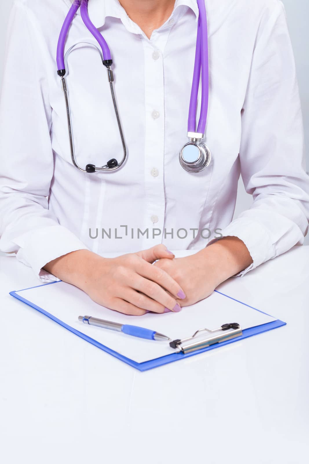 female doctor with hands on table very close up