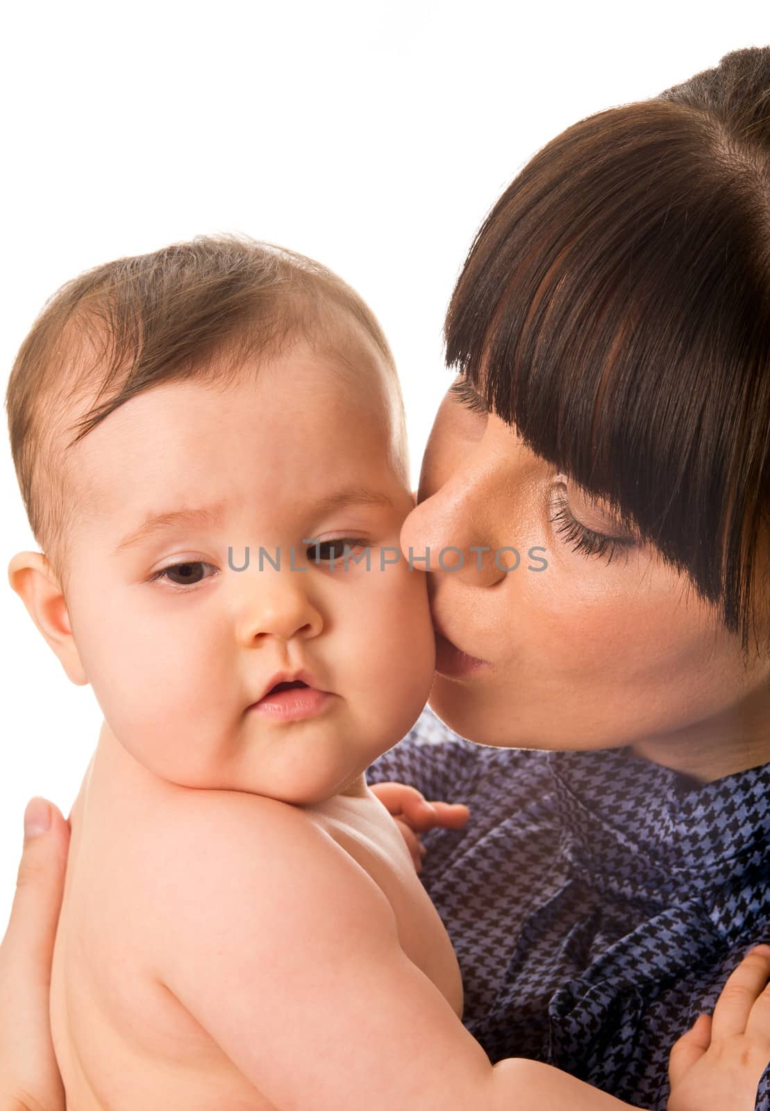 Portrait of mother kissing her baby isolated on white