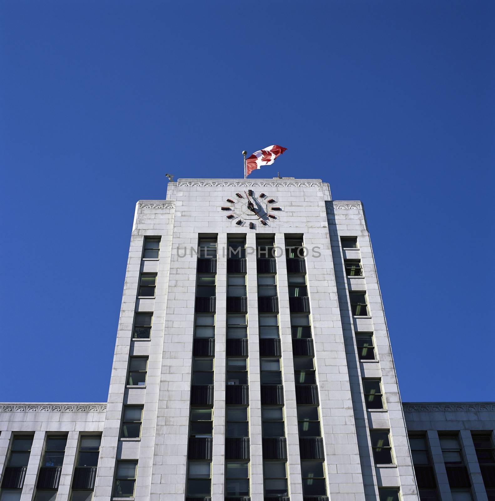 Large city hall building with canadian flag