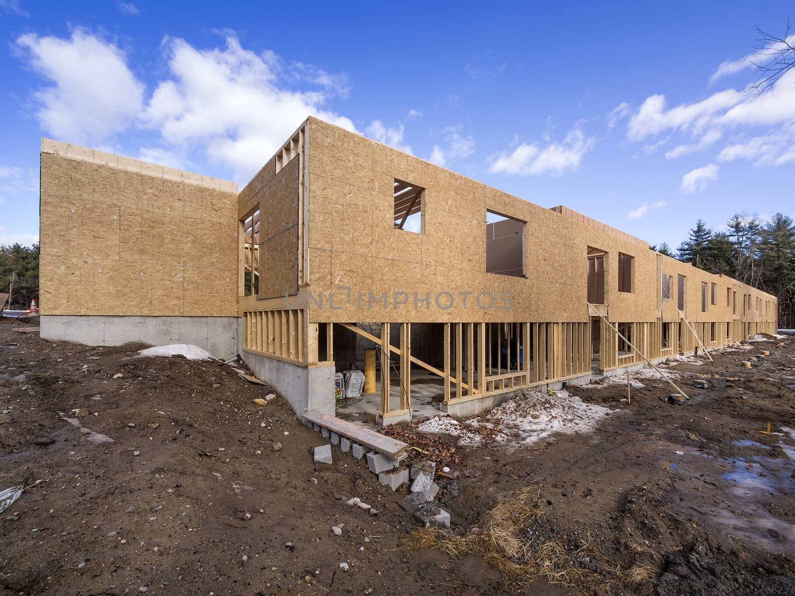 New framing house construction with no roof and two by fours exposed