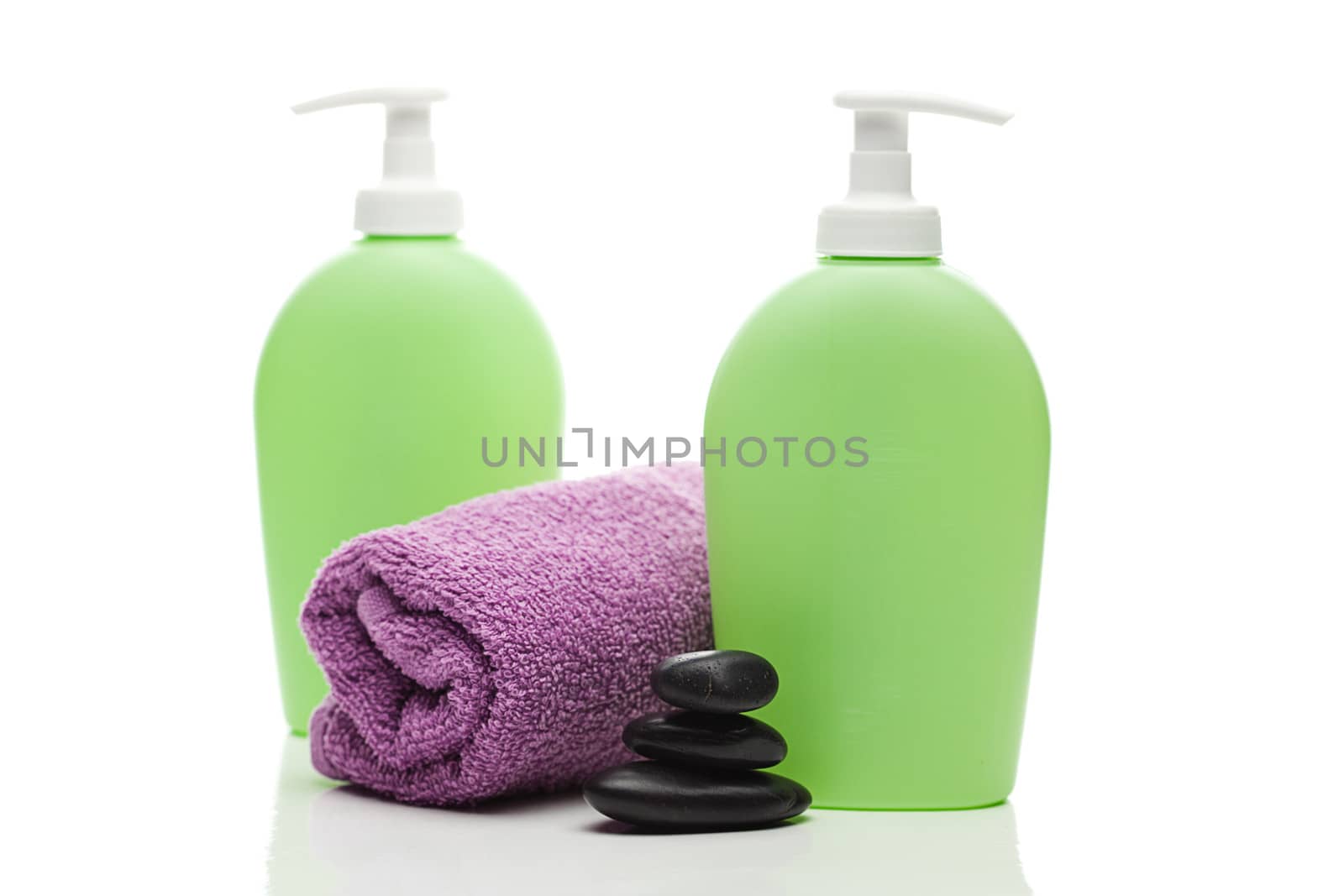 cosmetic containers, towel and spa stones isolated on white