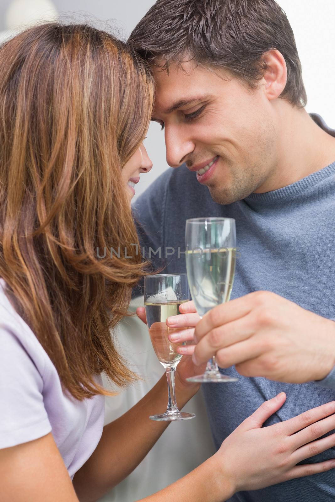 Close-up of a romantic couple with flutes at home by Wavebreakmedia