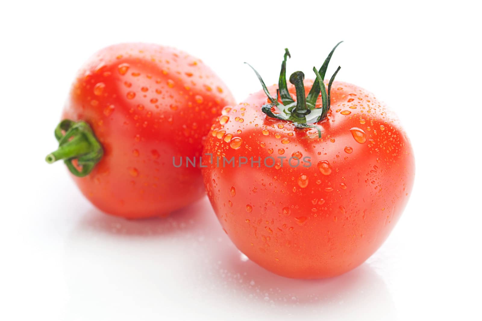tomato with water drops isolated on white by jannyjus