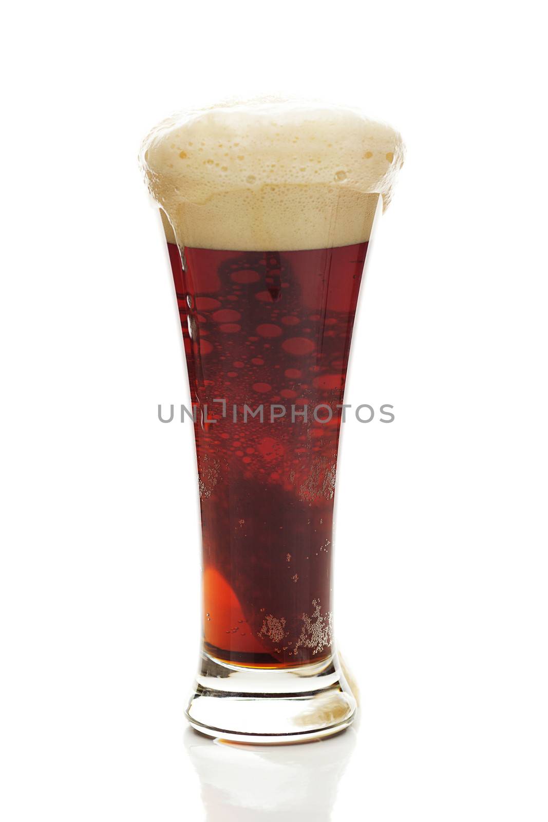 dark beer with the foam in a tall glass isolated on white