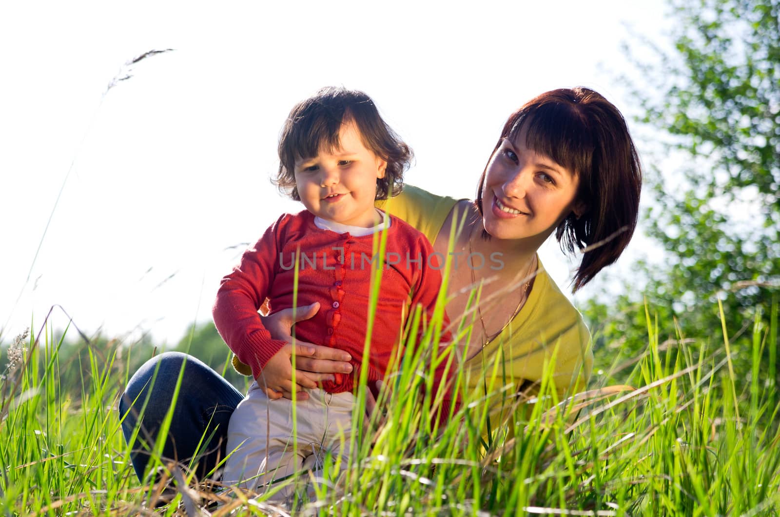 Little girl with young woman on meadow