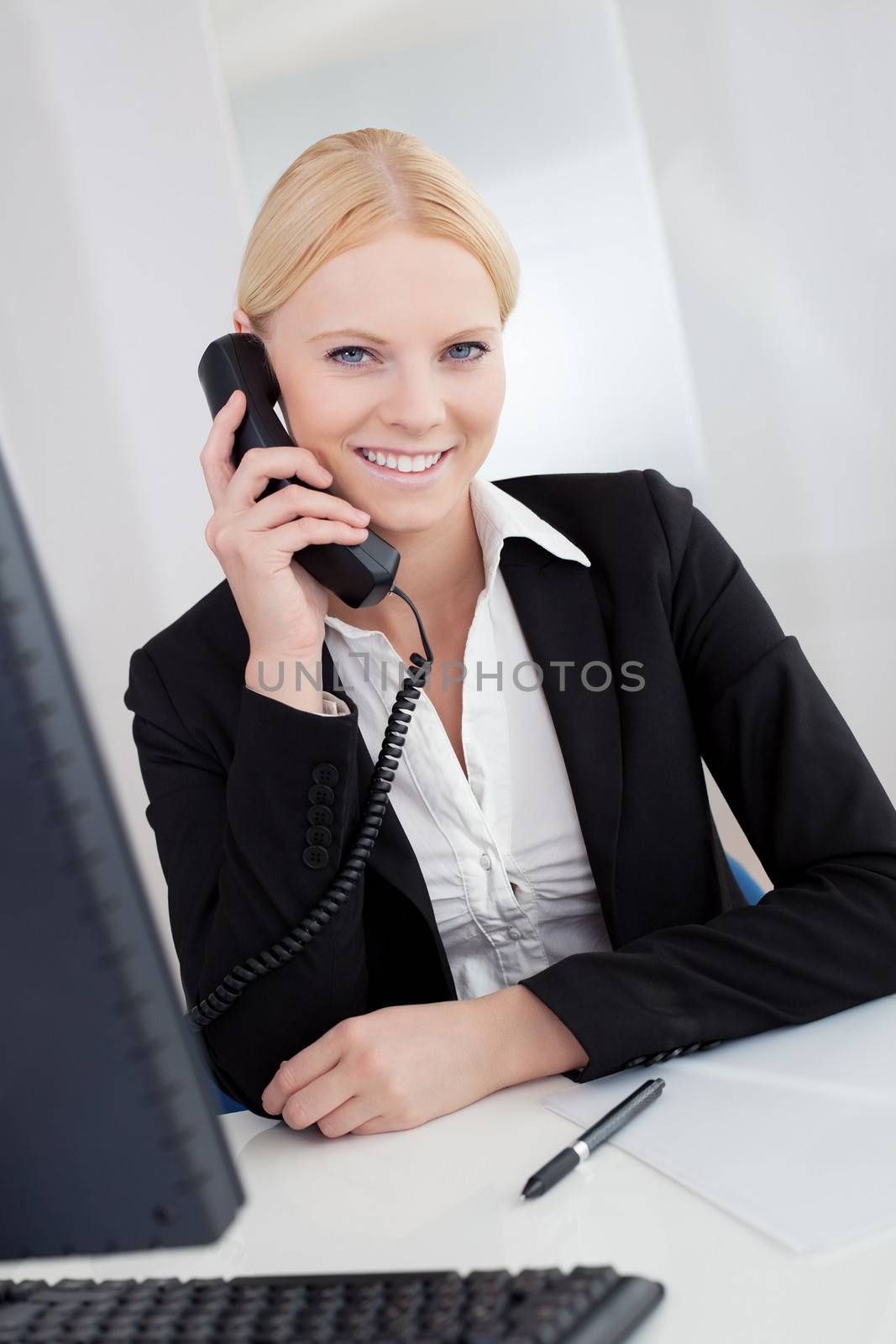 Beautiful businesswomen talking on the phone in the office
