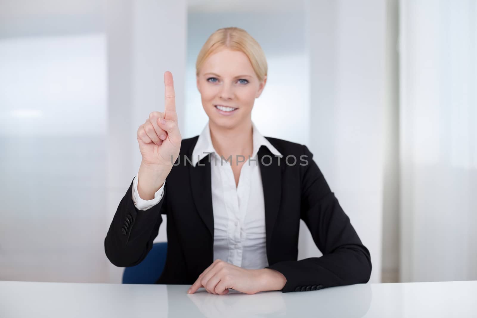 Business woman touching the screen with her finger by AndreyPopov