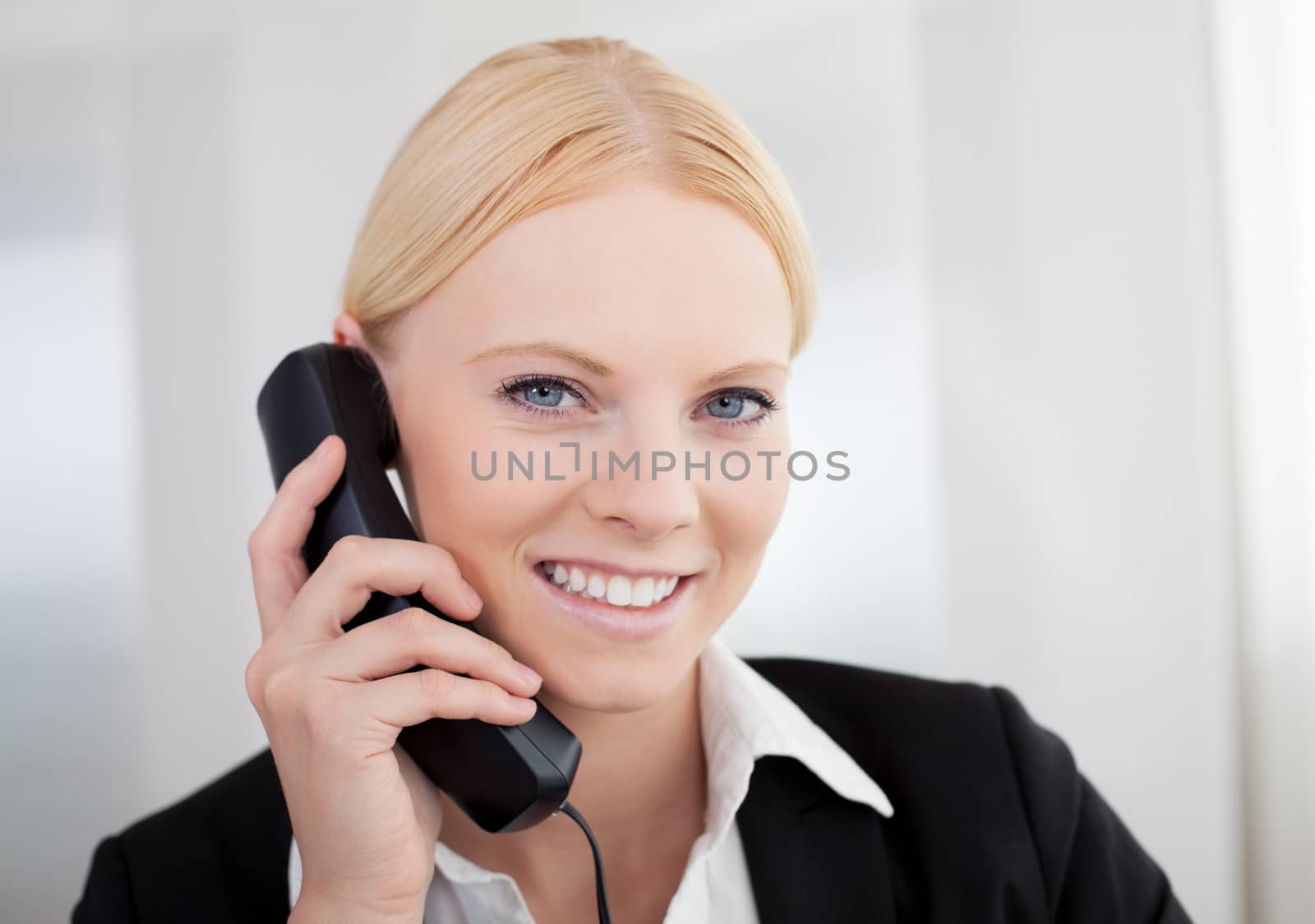 Beautiful businesswomen talking on the phone by AndreyPopov