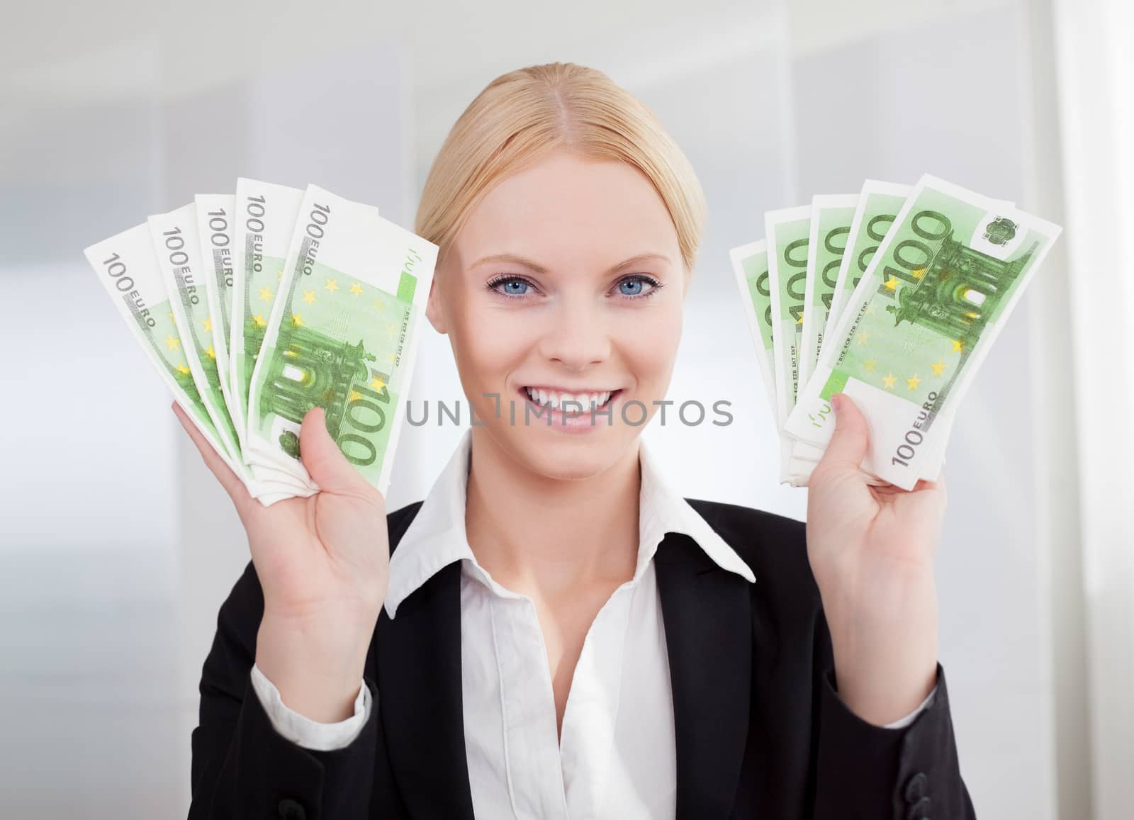 Businesswoman holding euro currency notes in the office