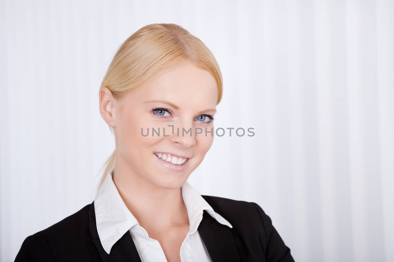 Portrait of cheerful young businesswoman in the office