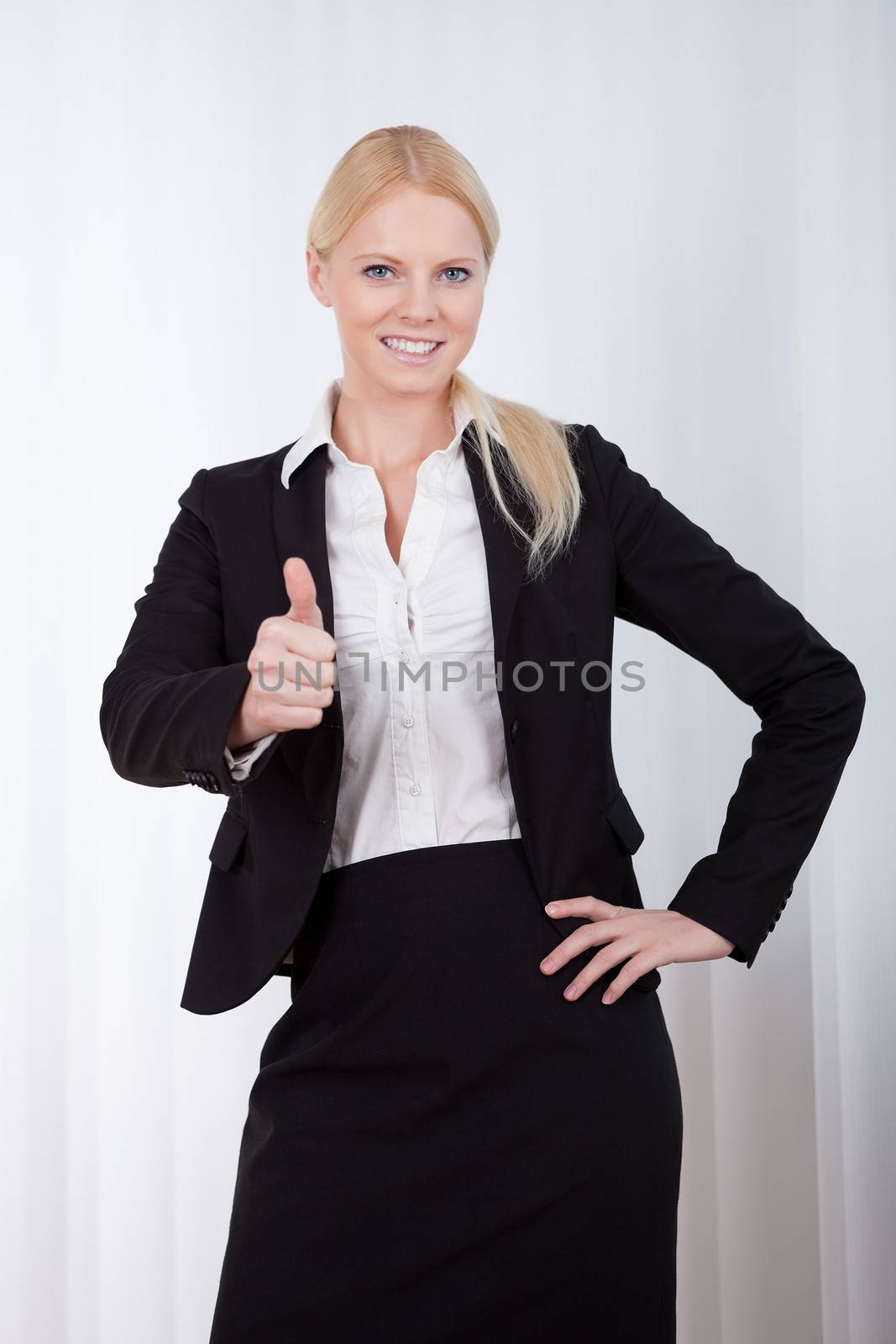 Portrait of cheerful young businesswoman in the office