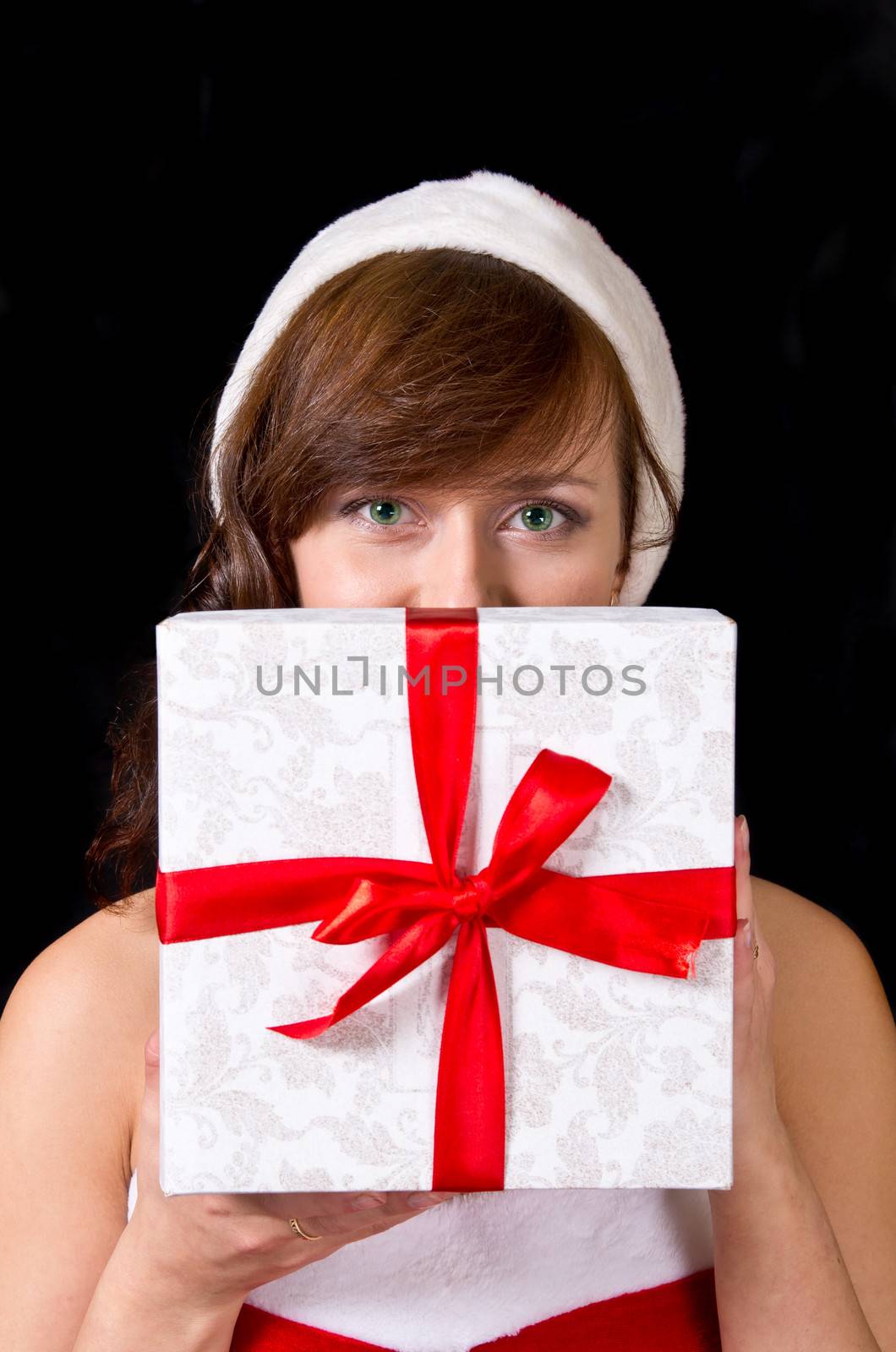 Young woman with gift box isolated on black