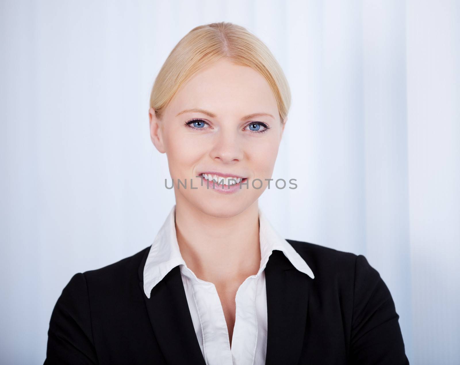 Portrait of cheerful young businesswoman in the office