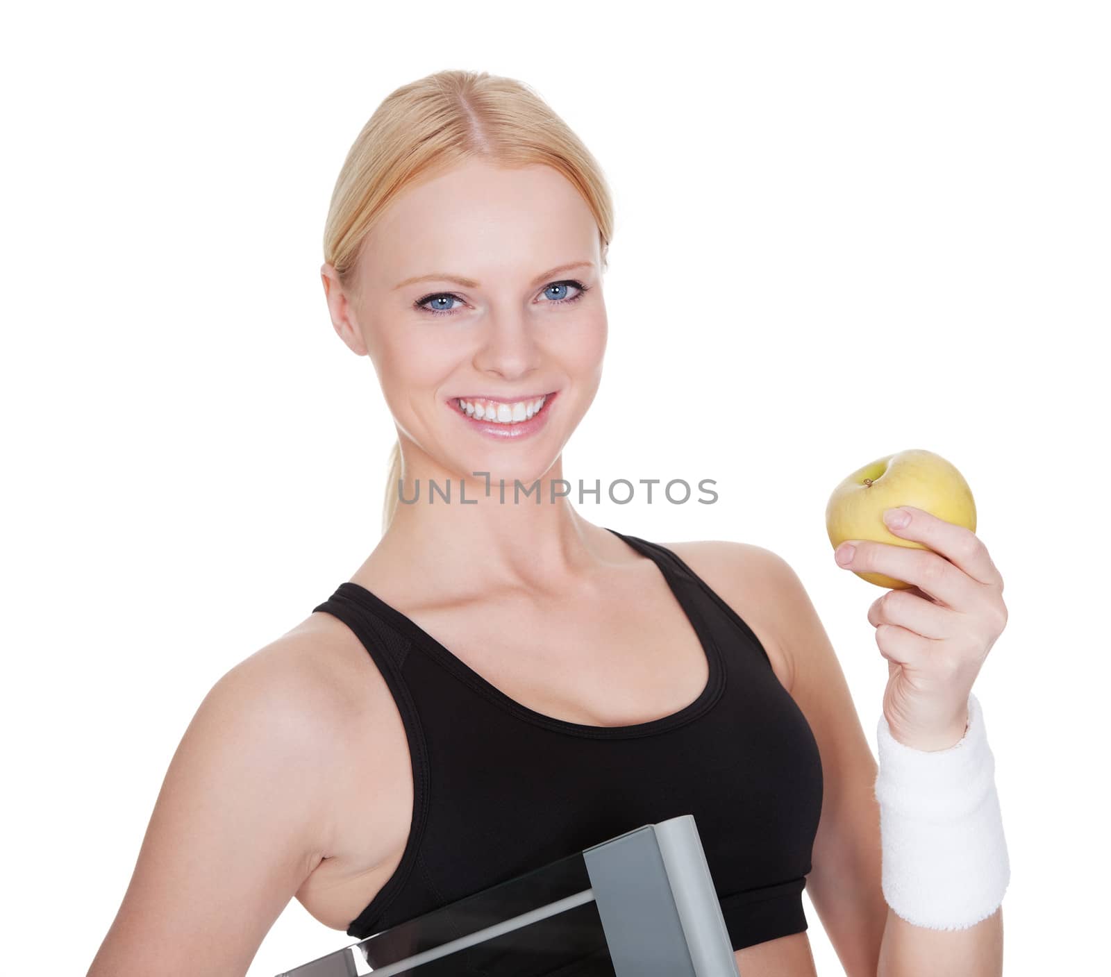 Beautiful young fitness woman with weights and apple. Isolated on white