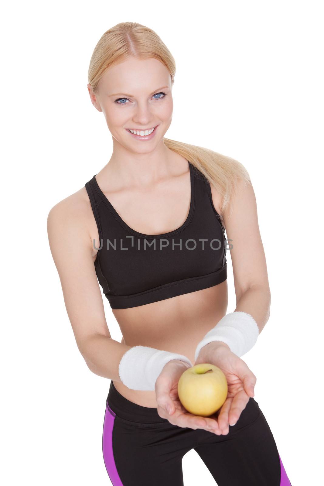 Beautiful young fitness woman holding apple. Isolated on white