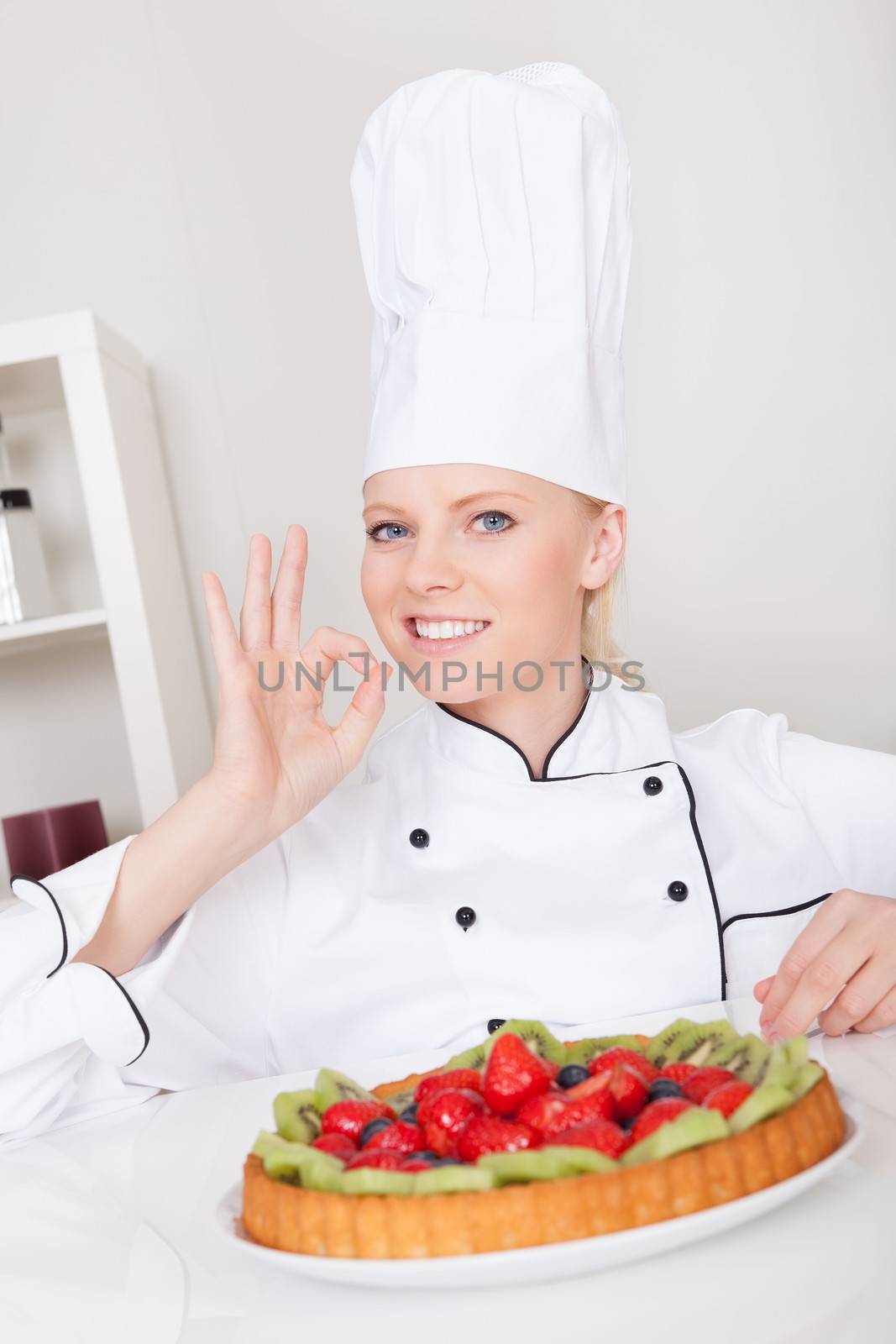 Beautiful chef woman making cake in the kitchen