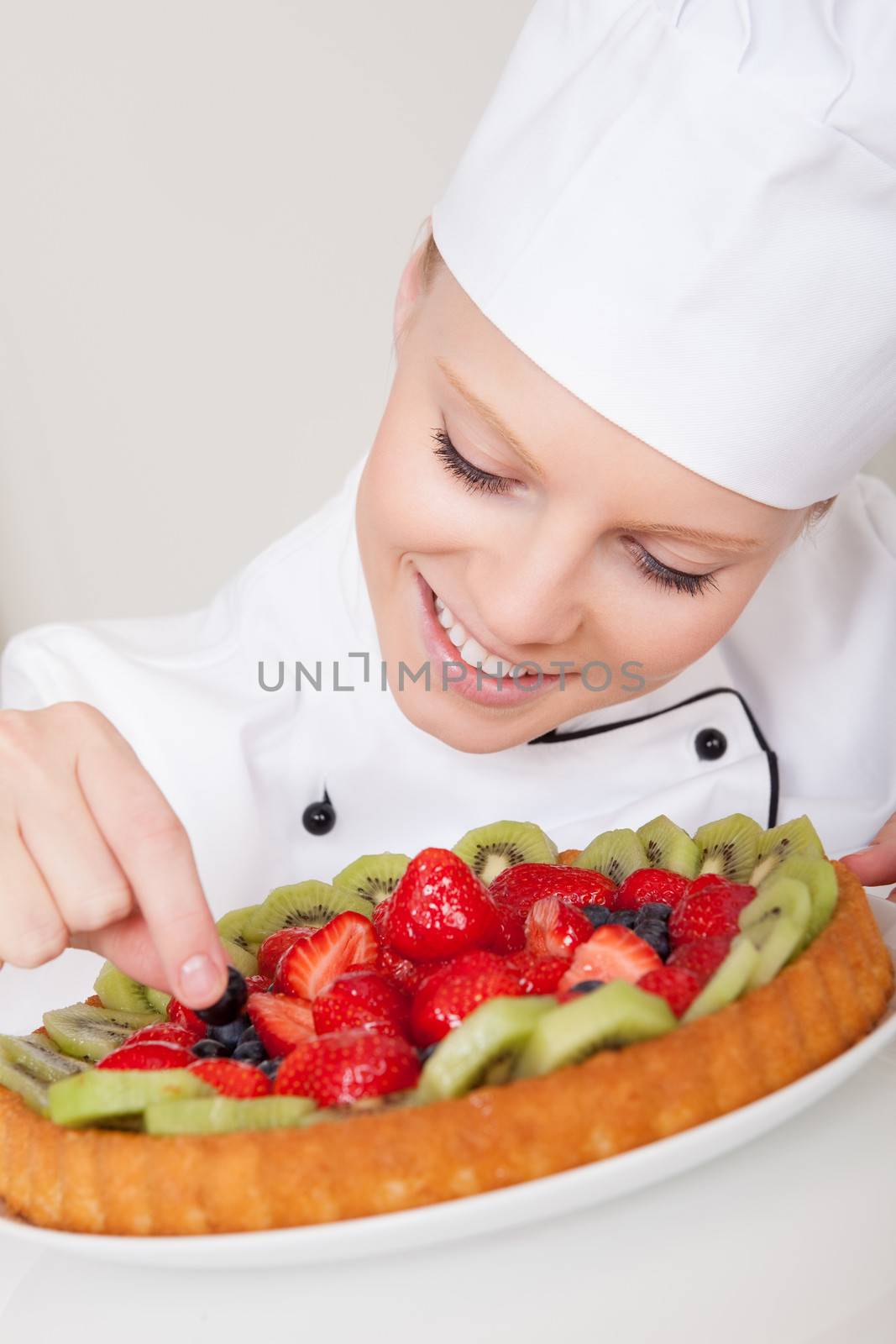 Beautiful chef woman making cake by AndreyPopov