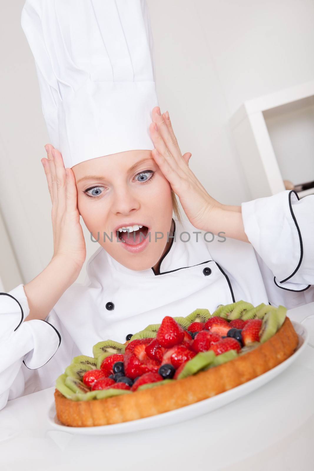 Beautiful chef woman making cake in the kitchen