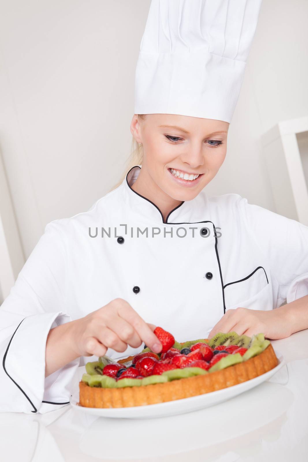 Beautiful chef woman making cake by AndreyPopov