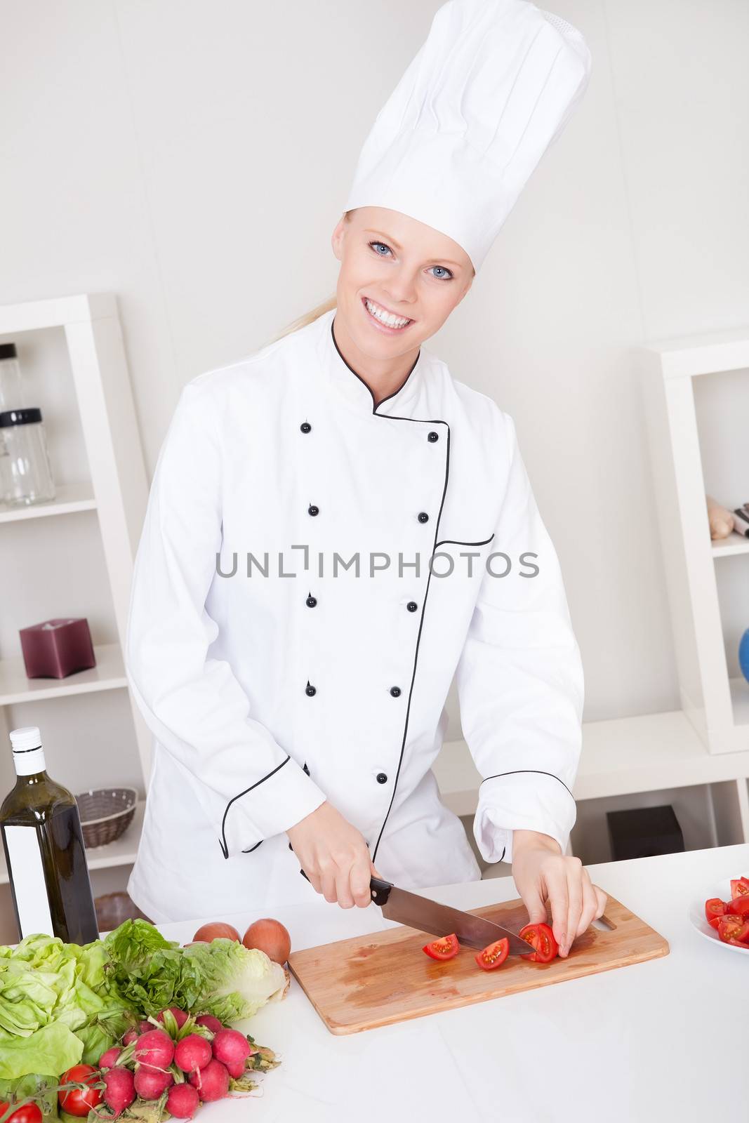 Cheerful woman chef cooking by AndreyPopov