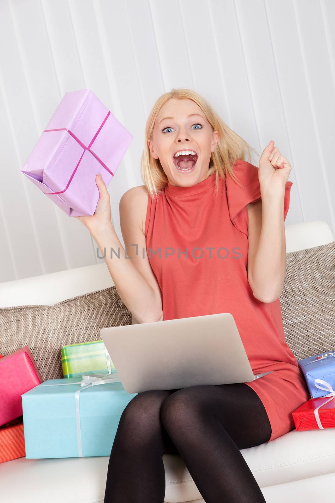 Beautiful young woman buying presents in Internet