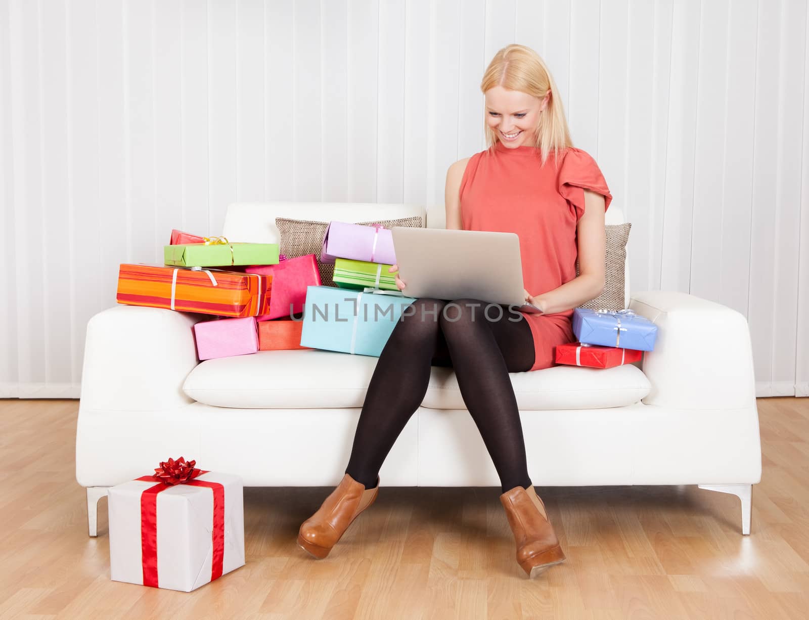 Beautiful young woman buying presents in Internet