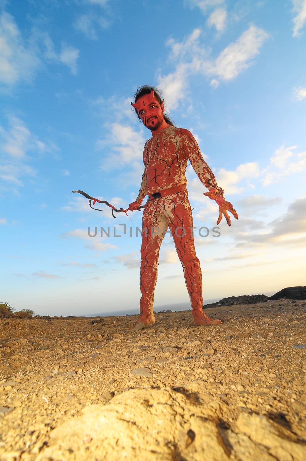 Latin American Man with Long Hairs Masked as a Devil in the Desert