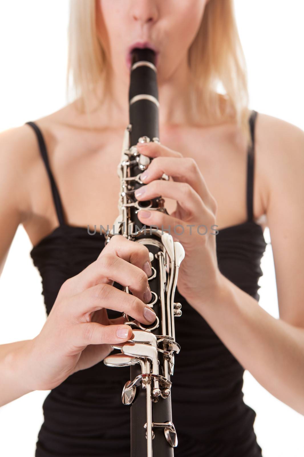 Beautiful young woman playing clarinet by AndreyPopov