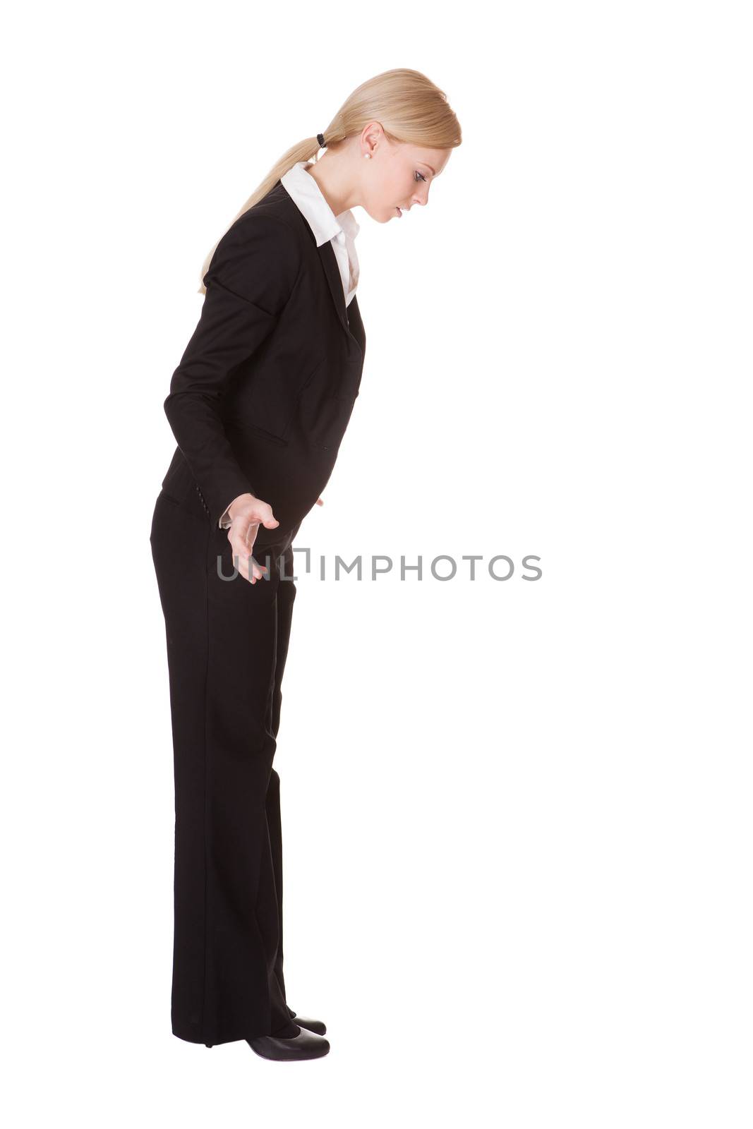 Stressed businesswoman ready to jump. Isolated on white