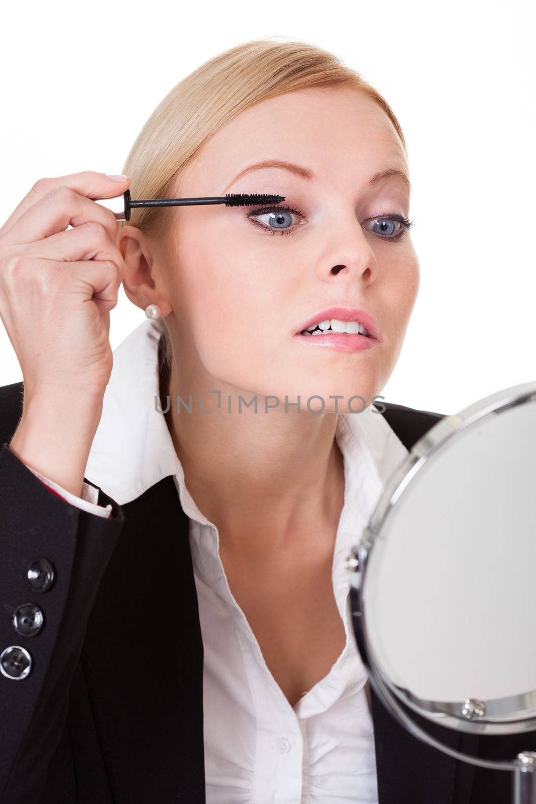 Attractive businesswoman applying mascara by AndreyPopov