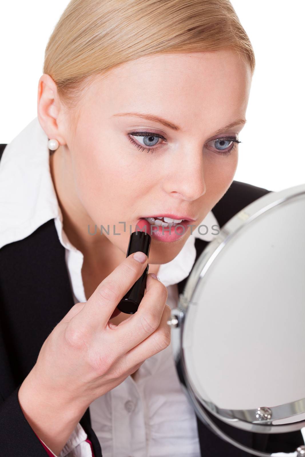 Attractive businesswoman applying lipstick. Isolated on white