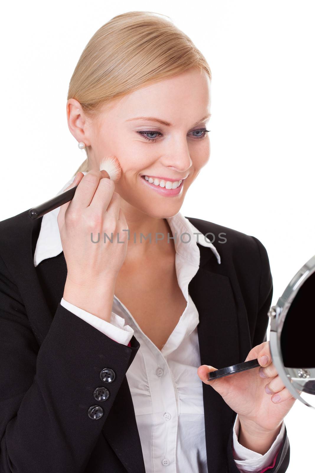 Attractive businesswoman applying foundation. Isolated on white