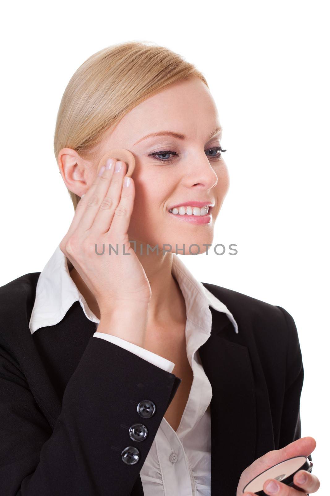 Attractive businesswoman applying foundation. Isolated on white