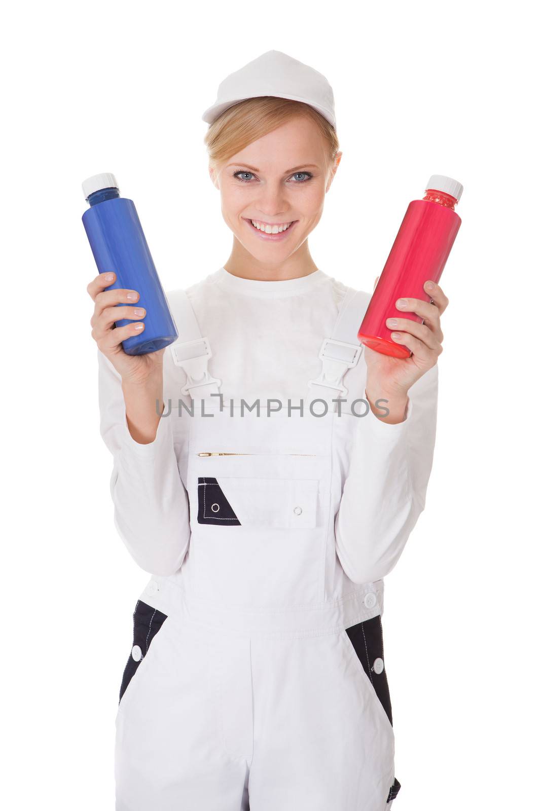 Professional young painter woman holding two buckets of paint. Isolated on white