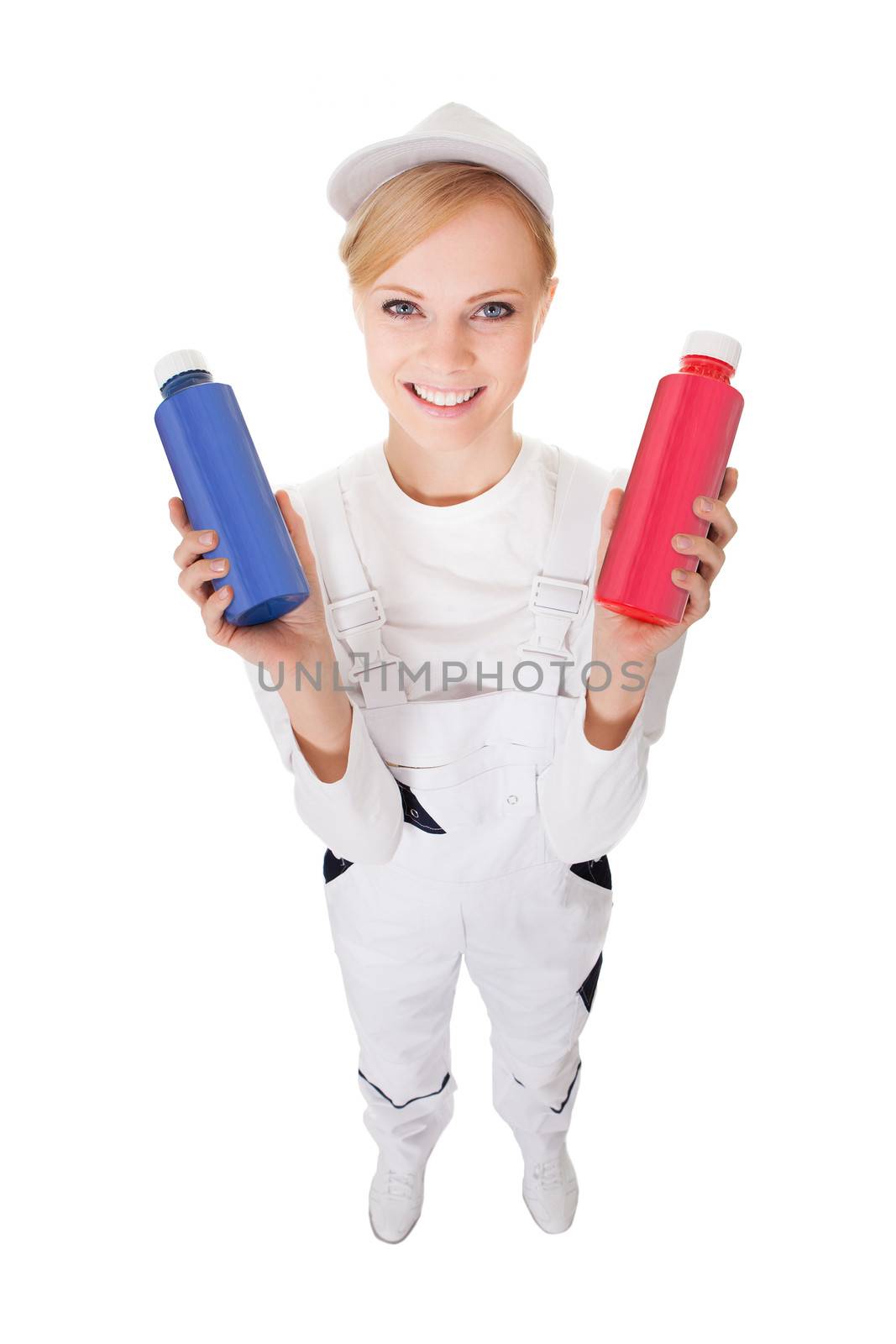 Professional young painter woman holding two buckets of paint. Isolated on white