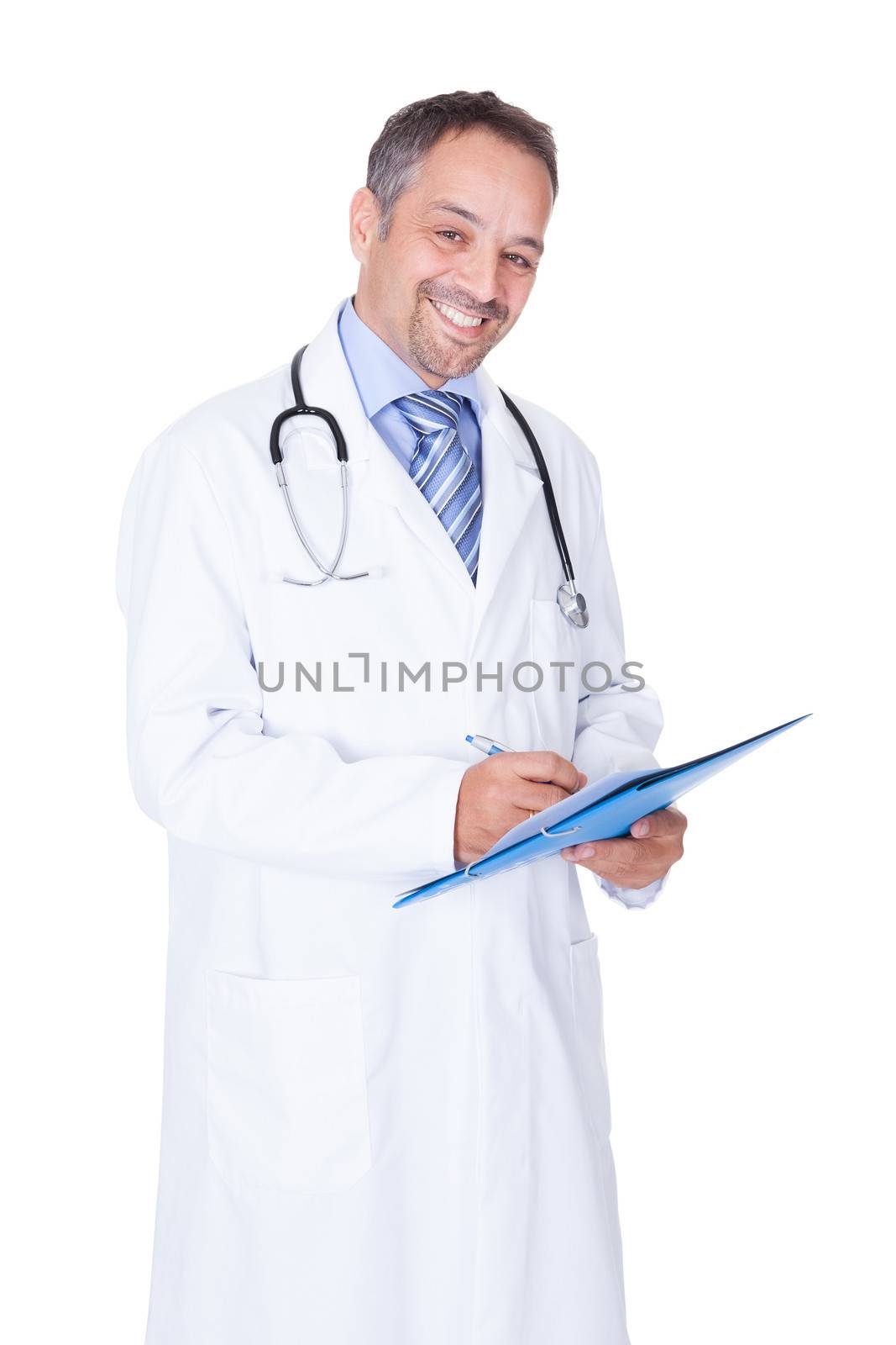 Portrait Of Happy Doctor Writing On Paper