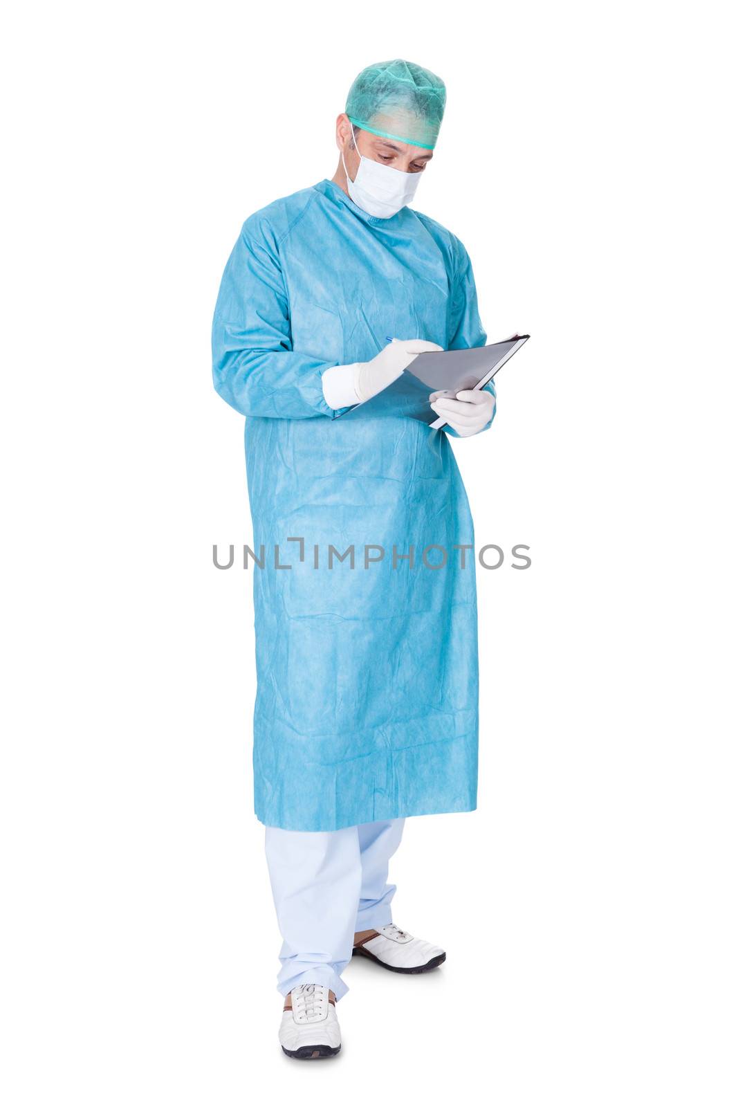 Portrait Of Doctor In Operation Gown Writing On Folder Isolated On White Background