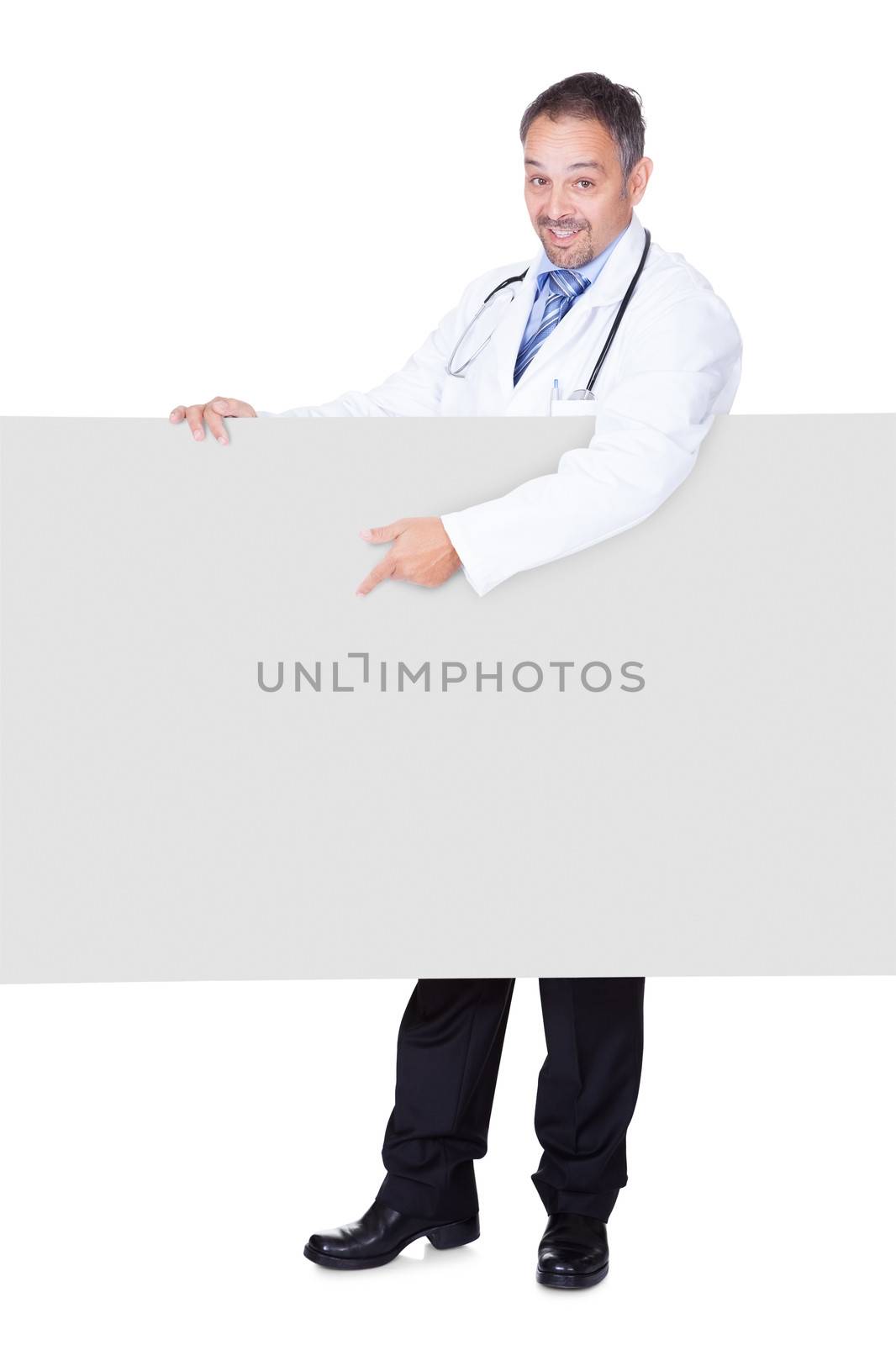 Portrait Of A Doctor Holding Blank Placard Isolated On White Background