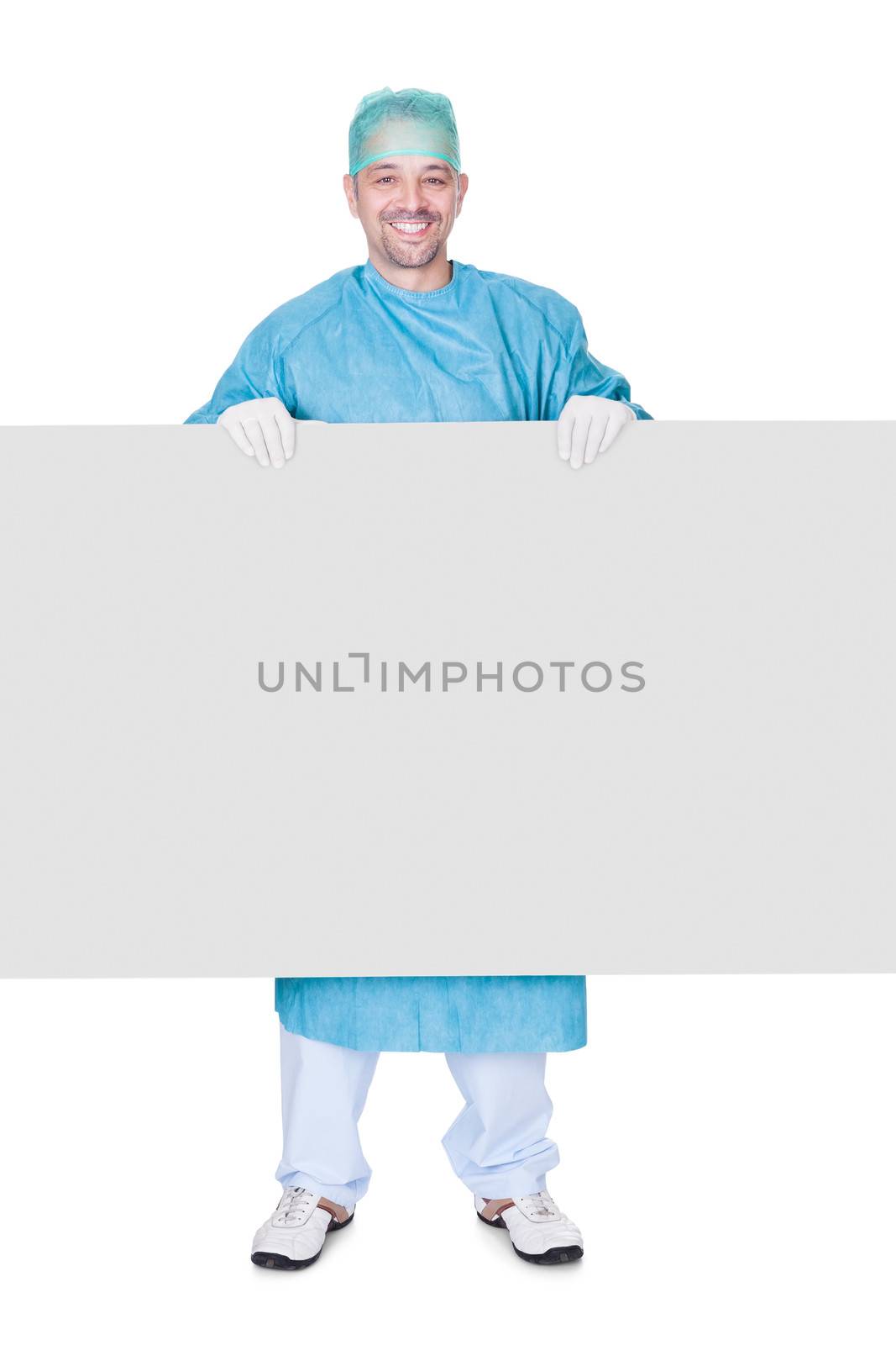 Doctor In Operation Gown Holding Blank Placard On White Background
