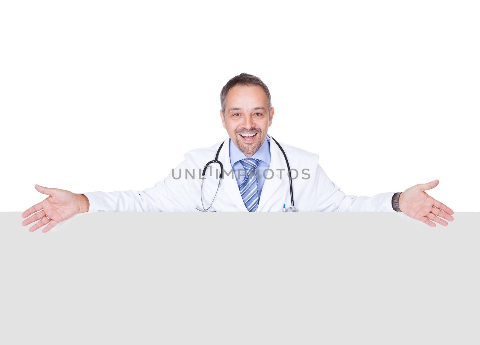 Portrait Of A Doctor Holding Blank Placard Isolated On White Background