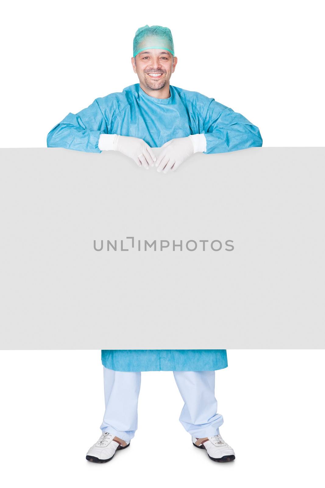 Doctor In Operation Gown Holding Blank Placard On White Background