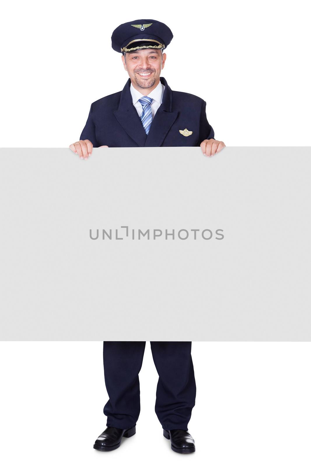 Portrait Of Happy Pilot Holding Blank Placard by AndreyPopov